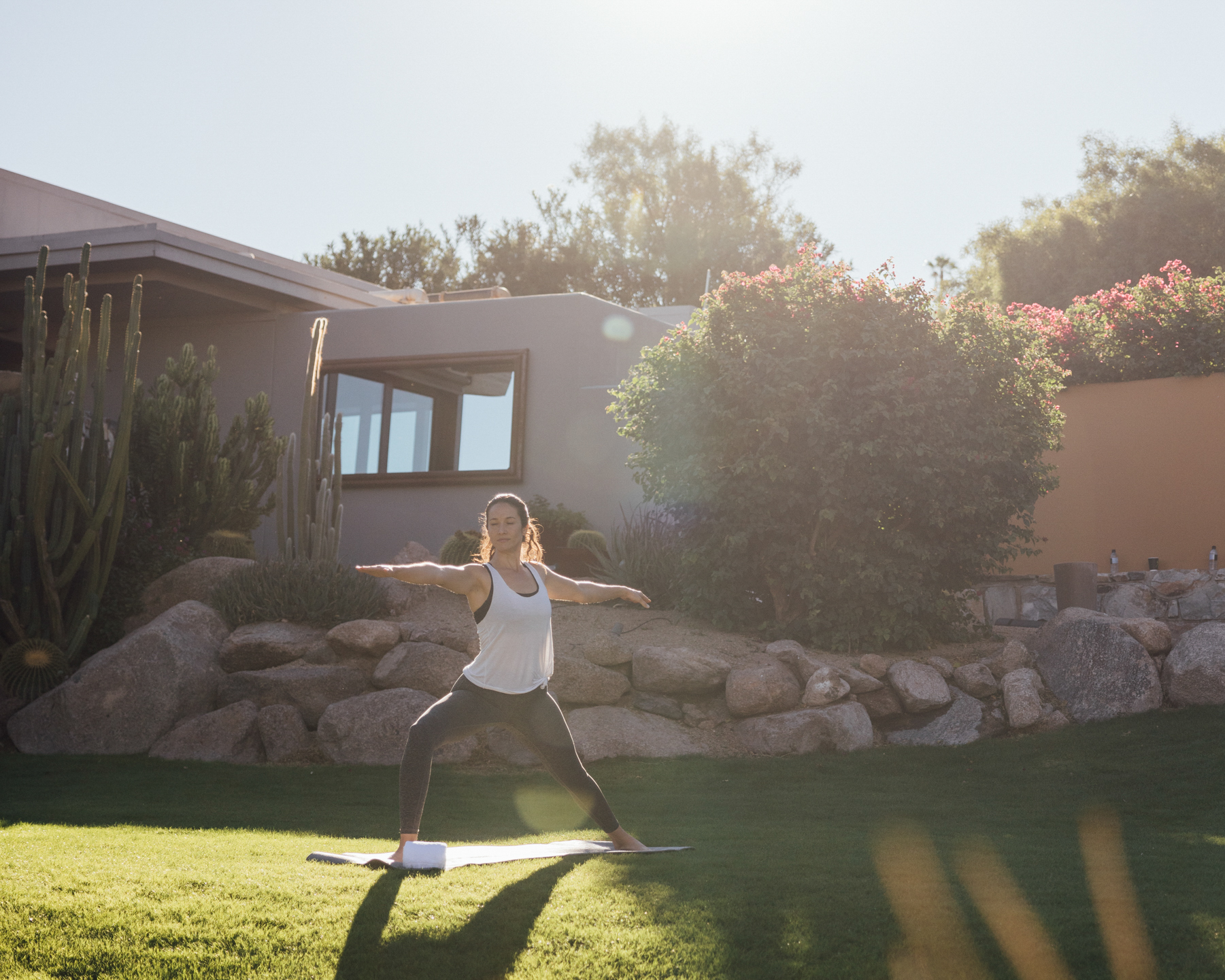 Woman doing yoga at sunrise on Sanctuary's Sunset Garden.