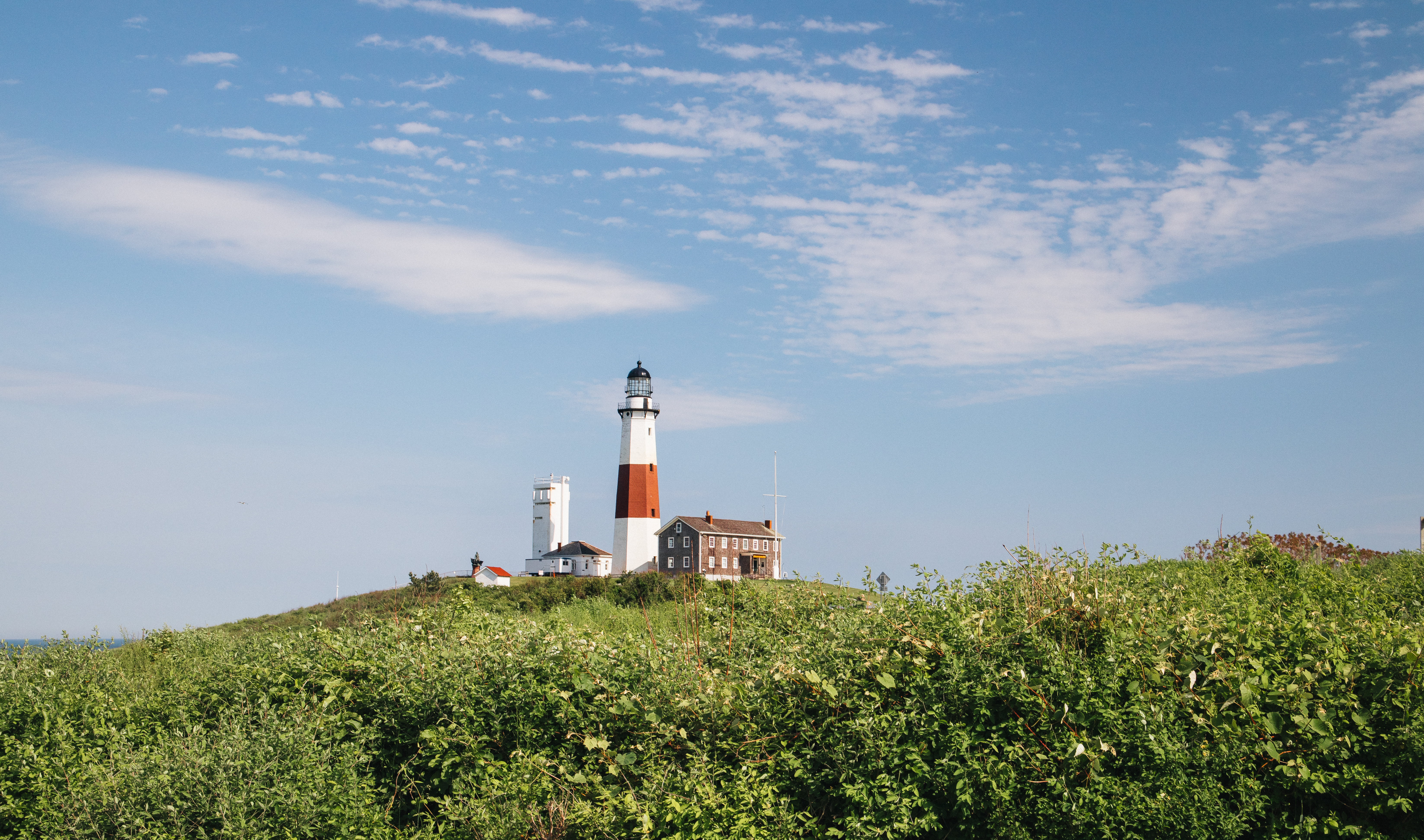 View of small town Montauk from across a green field.