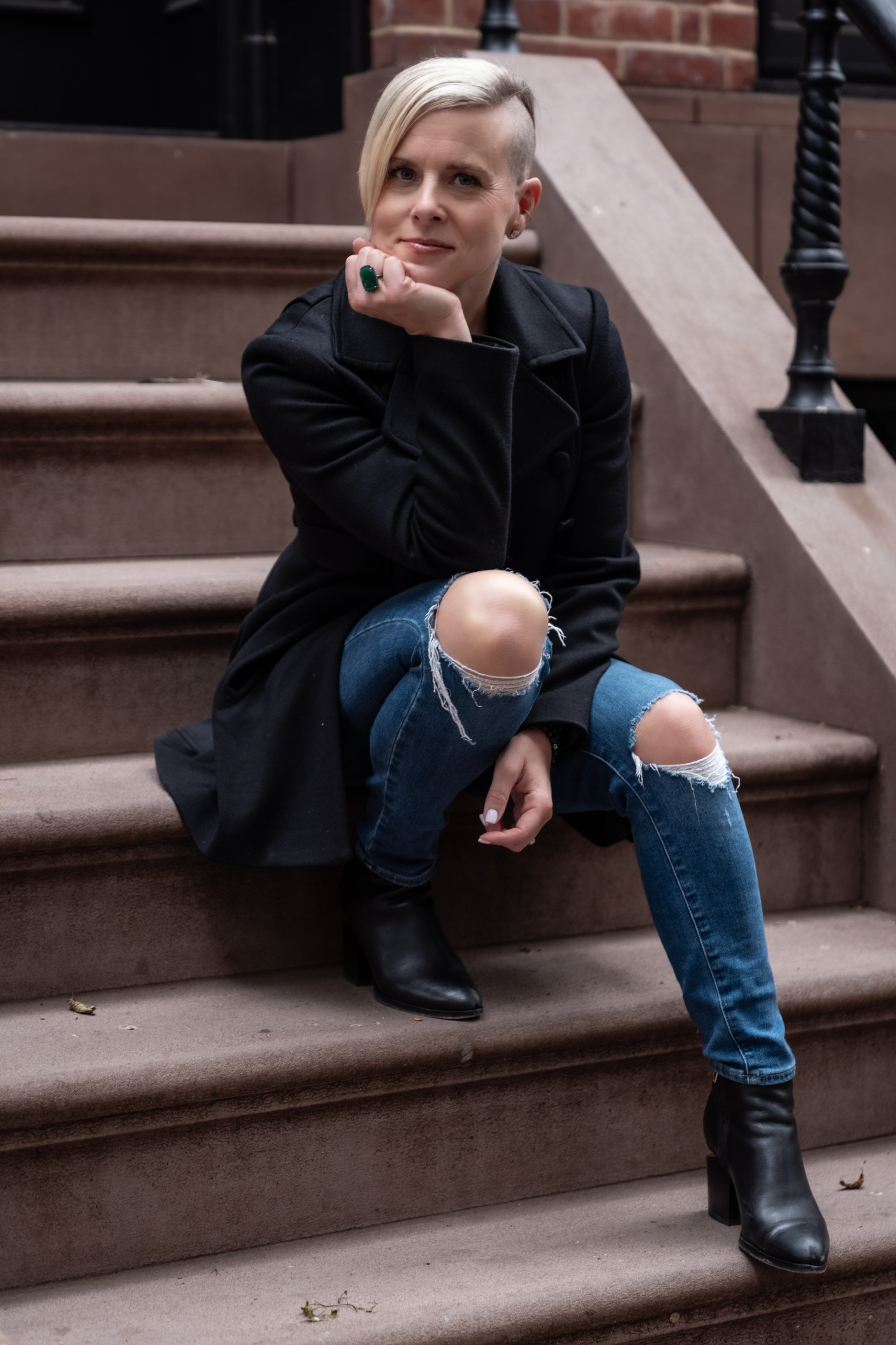Lady sitting on a staircase outside