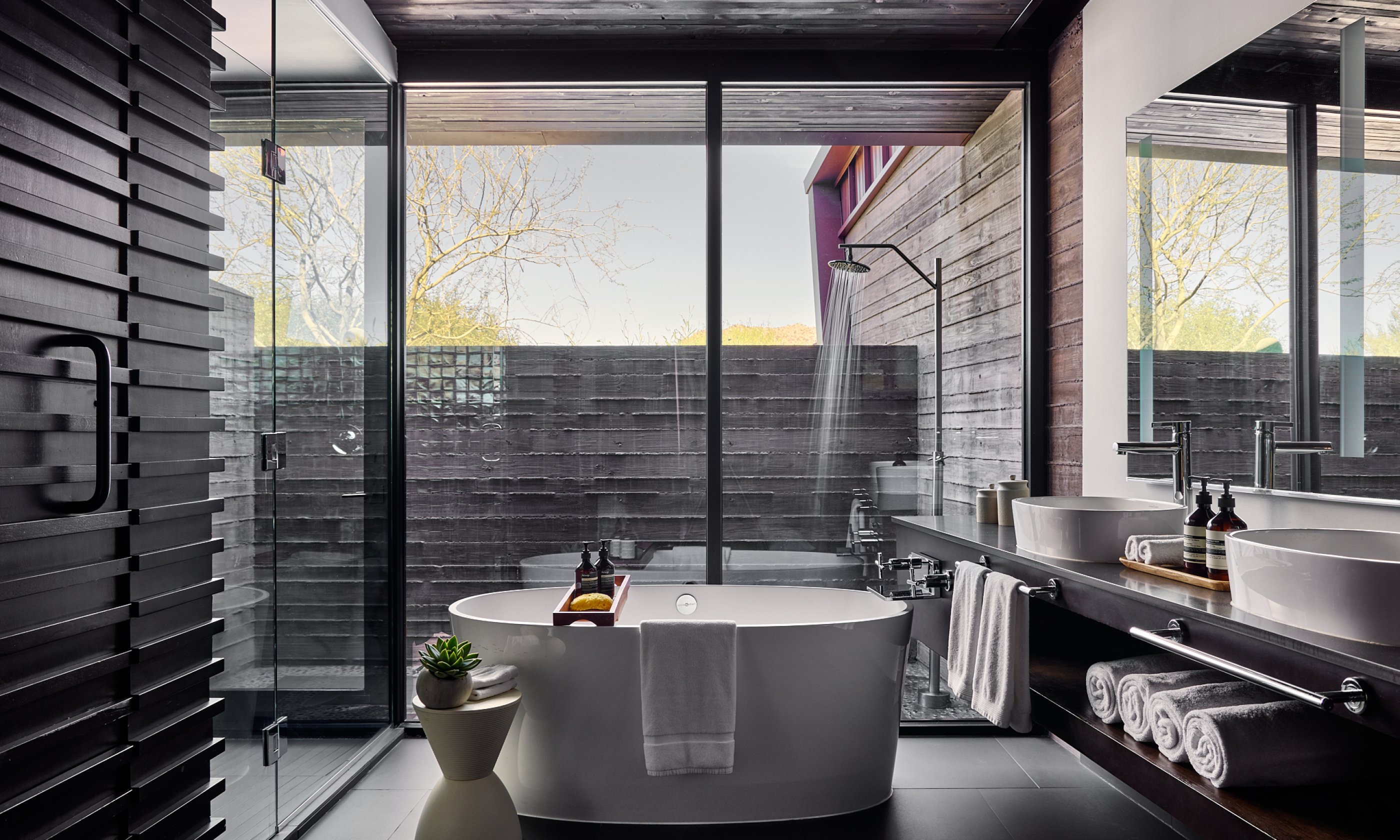 Bathroom with two sinks, vanity, soaking tub and outdoor shower.