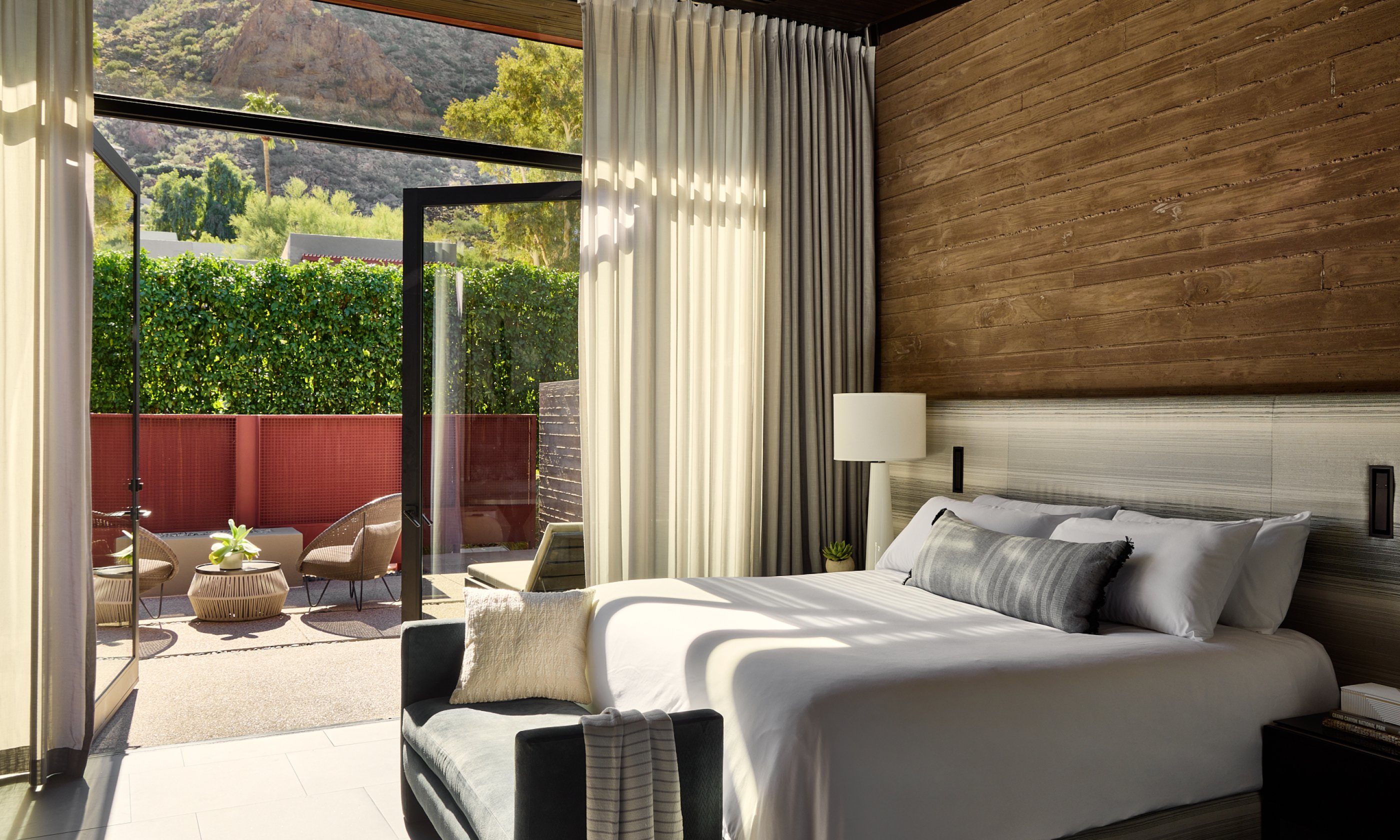 Terrace Casita with king bed, glass door, and outdoor patio with a view of Camelback Mountain.