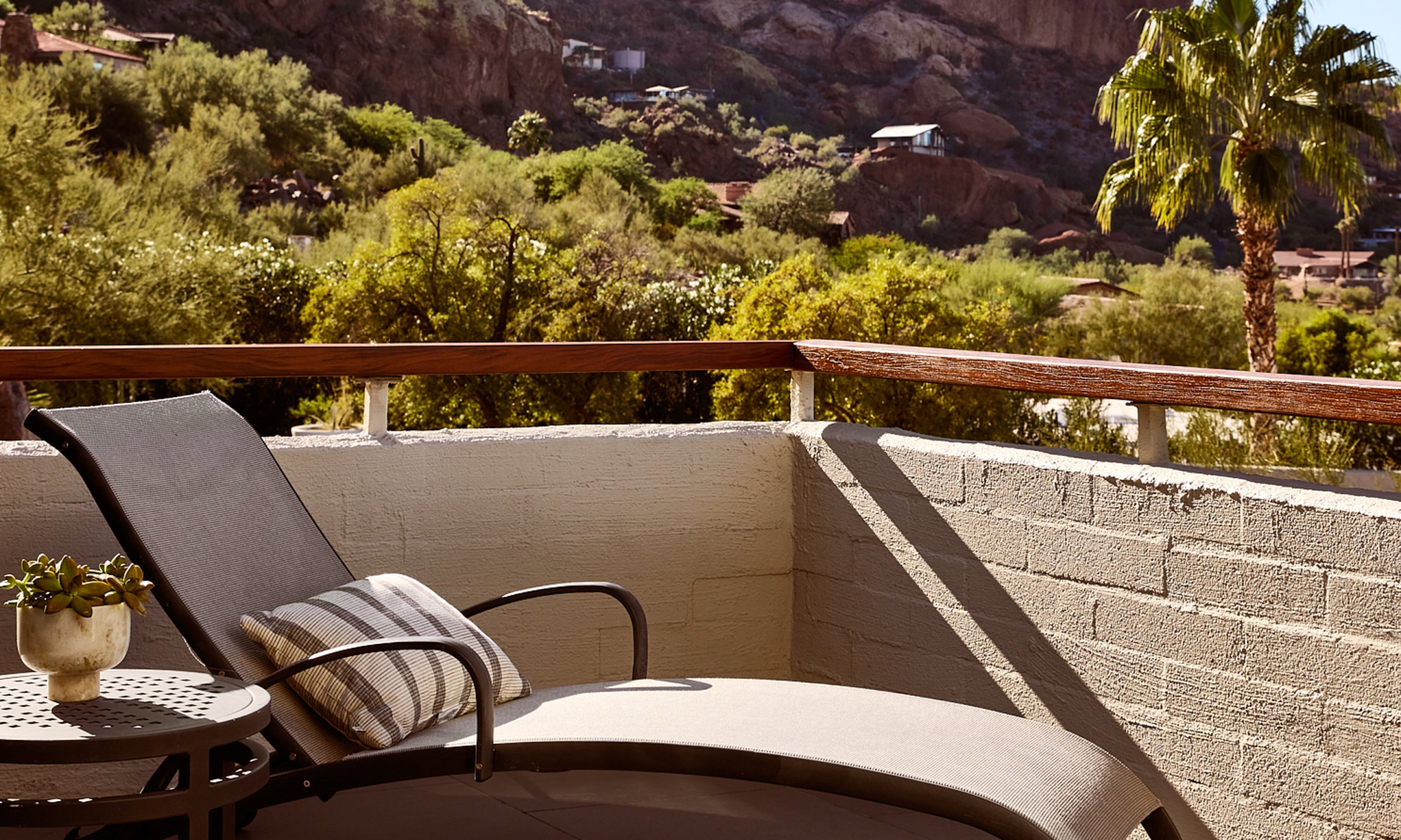Outdoor patio with lounge chair and table.