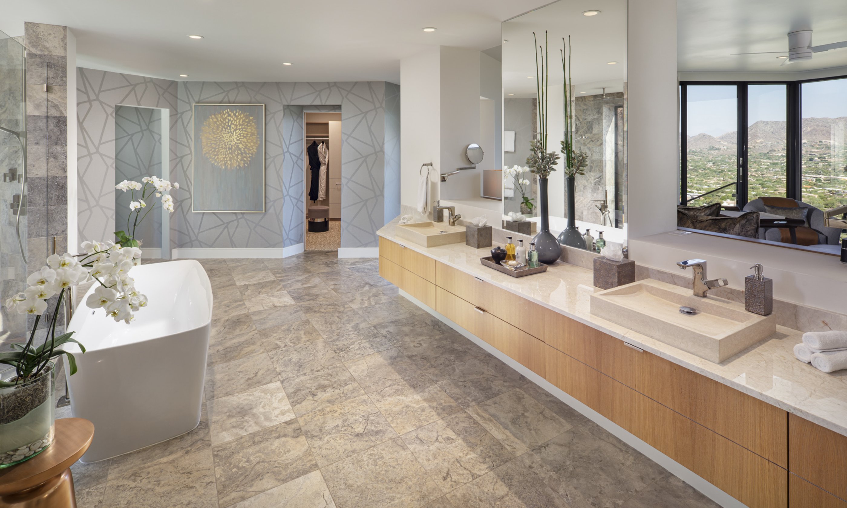 Master bathroom with soaking tub, two sinks, vanity and view of master bedroom.