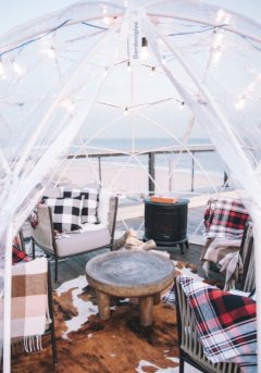 Cozy furniture inside a clear dining igloo