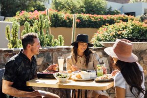 Friends enjoying weekend brunch on elements' Praying Monk Patio.