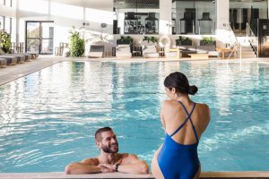 Couple relaxing in the indoor saltwater pool at Gurney's Seawater Spa.