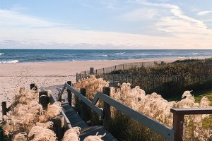 A boardwalk leading to the beach is framed by winter grasses at Gurney's Montauk Resort