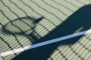 A silhouette of a person holding a tennis racquet 