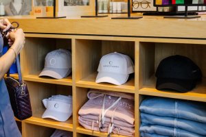 Close up of hats and clothes with Sanctuary and Gurney's branding in Scottsdale's retail shop.