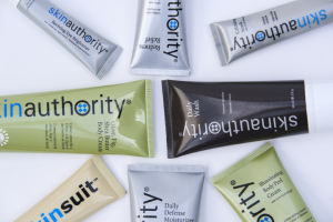 A colorful assortment of products from Skin Authority laid against a white background