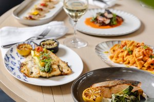 This is a table full of plates of food. 