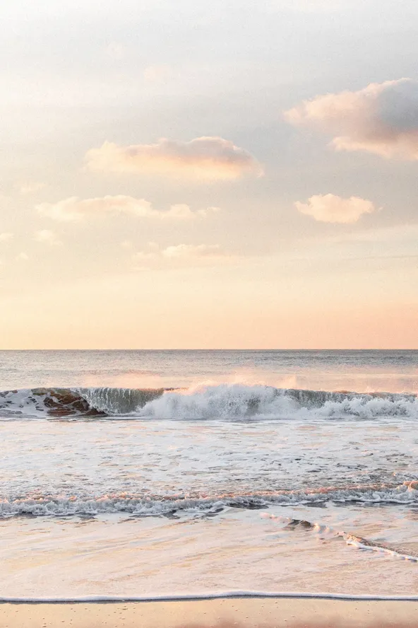Sunset with waves crashing on the beach