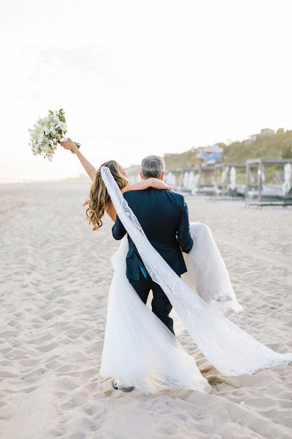 groom carrying bride