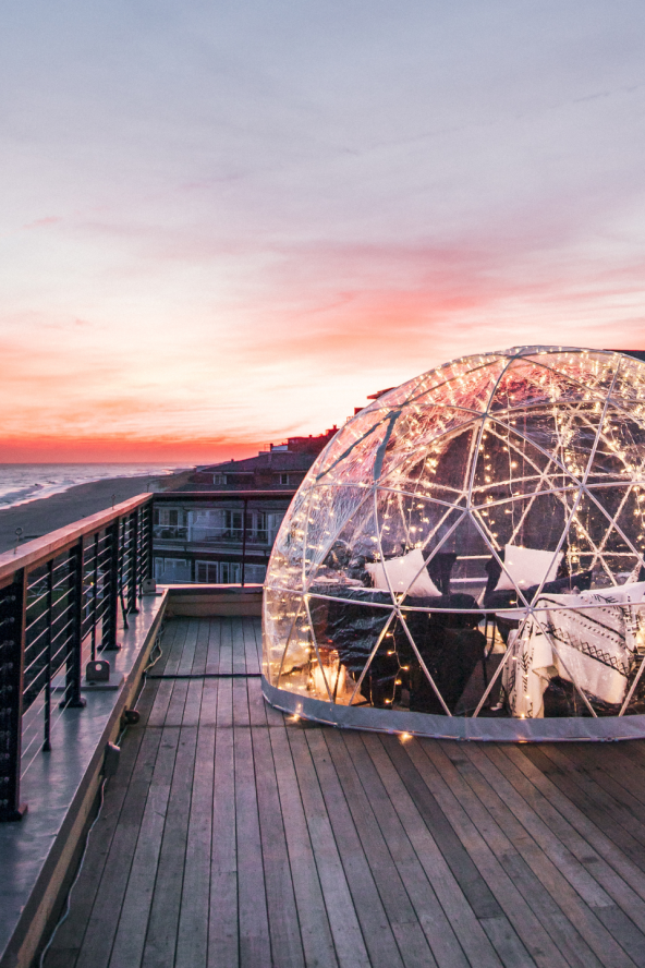 A dining igloo overlooking the ocean at sunset at Gurney's Montauk Resort