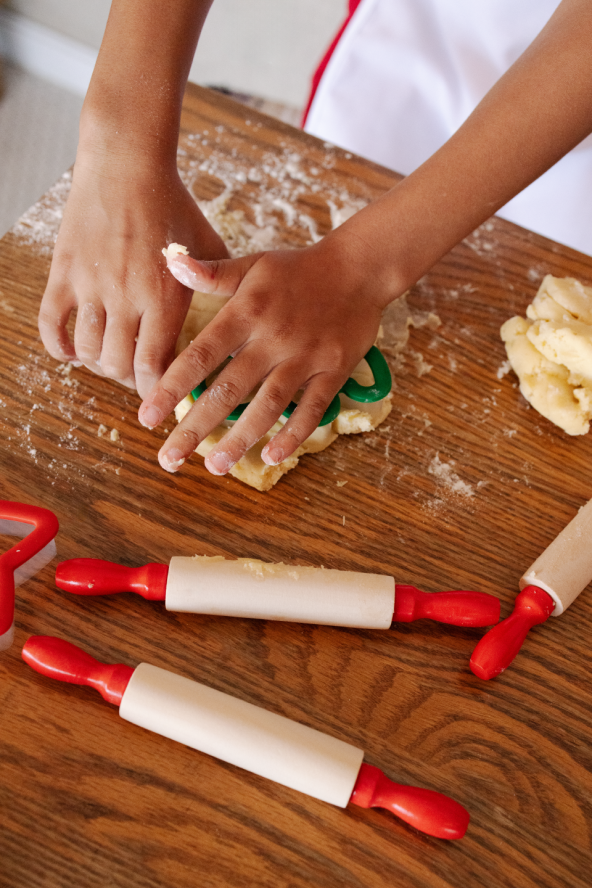 A closeup of a child playing with cookie dough