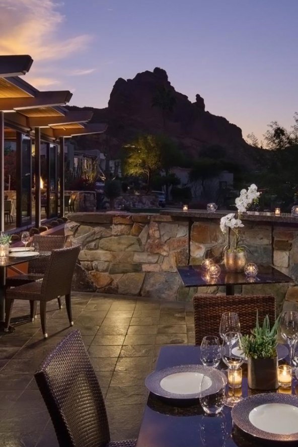 Elements sunset space outdoor dining deck with tables set for dinner and spectacular view of camelback mountain.