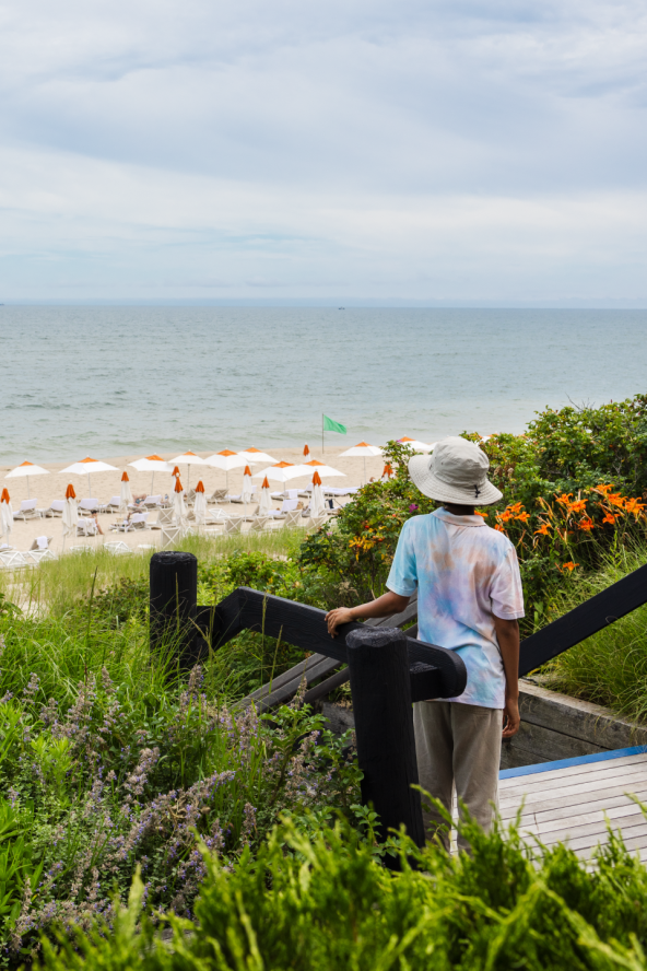 A boy looks out over the beach at Gurney's Montauk Resort