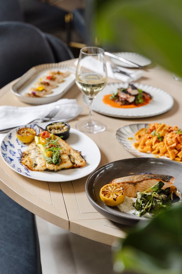 This is a table full of plates of food. 