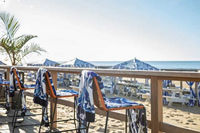 Beach Chairs with Blue and white towels facing the ocean