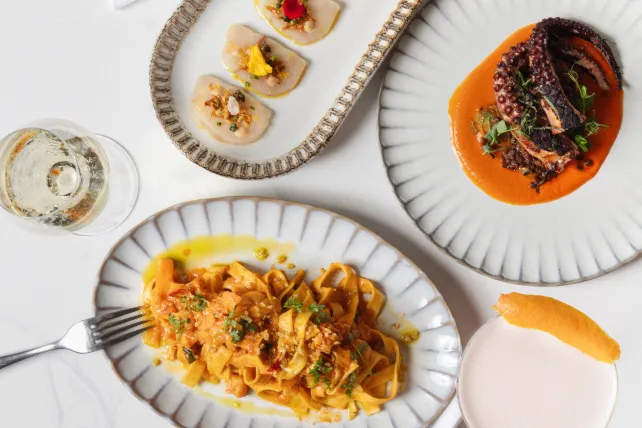 Pasta, sashimi, and octopus plated