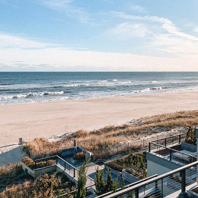 Ocean and beach viewed from a deck on the property