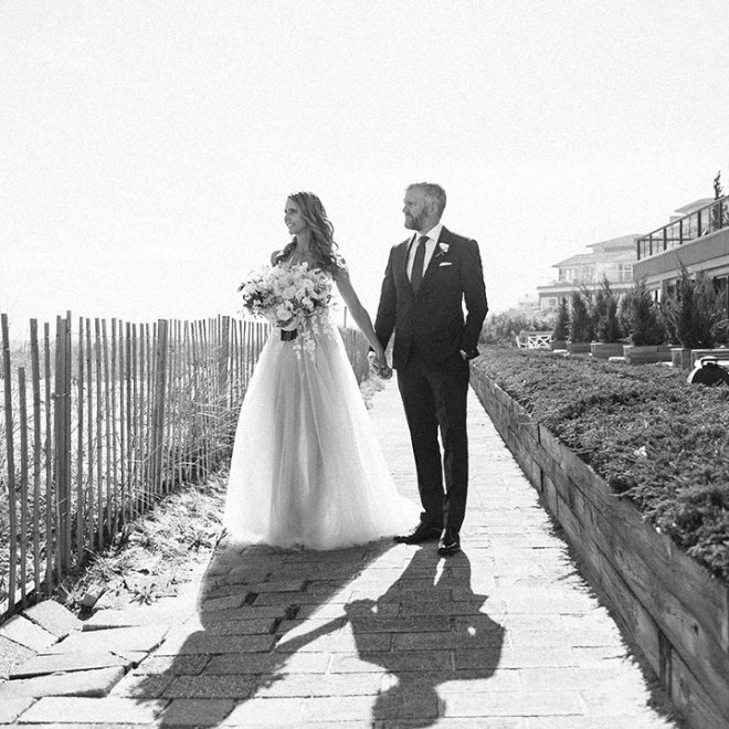 bride and groom on beach boardwalk