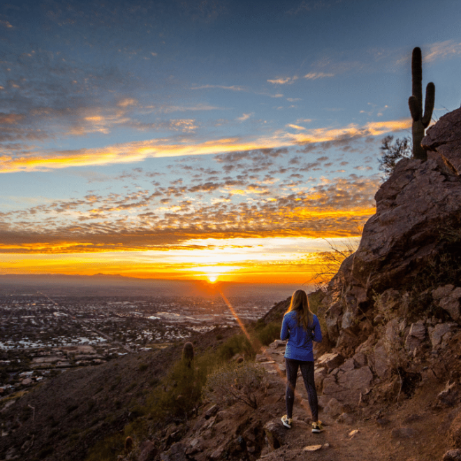 Hiking girl watching sunset