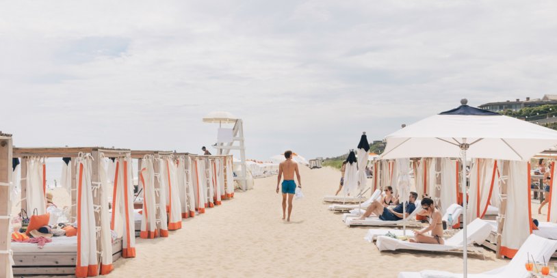 Man walking through Gurney's Montauk private beach.