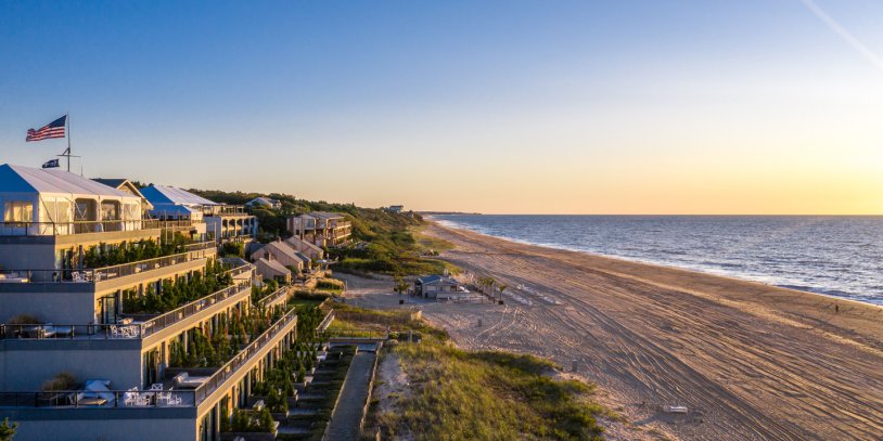 Drone view of Gurney's Montauk Resort and private beach at sunset.