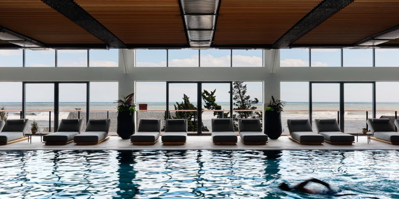 Person swimming laps in Gurney's Seawater Spa indoor pool.