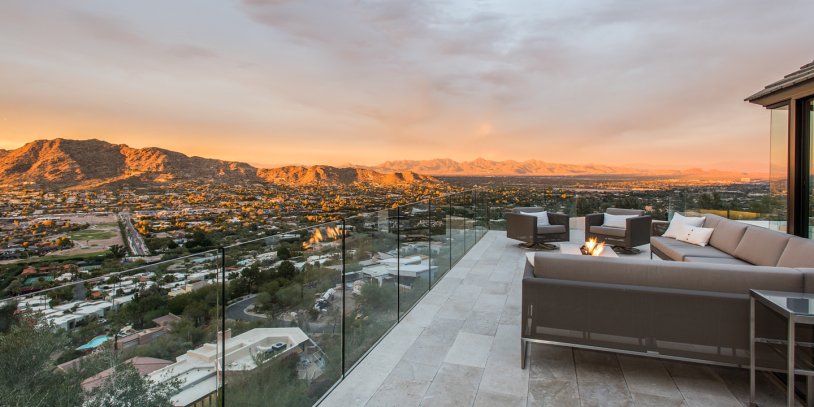 View from Villa Ventana patio at sunset with couch and fire pit.