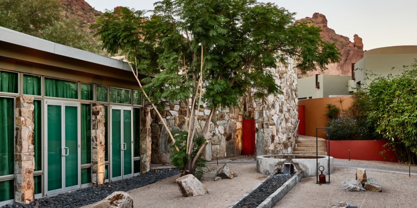 Sanctuary Spa Zen Garden with water feature, indoor-outdoor treatment rooms and view of Praying Monk.