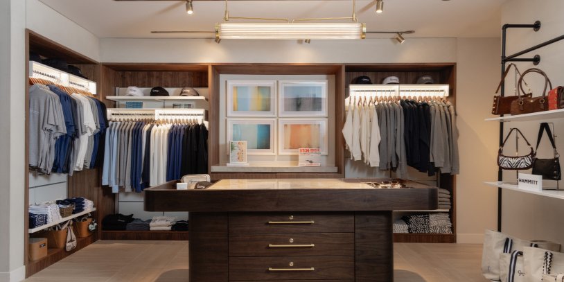 Retail Store full view. Center island with clothing around. 