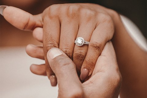 hands with engagement ring