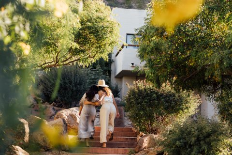 Two girlfriends walking through the landscape outside our Mountain Casitas and Suites.