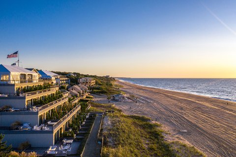 Drone view of Gurney's Montauk and beach at sunset.