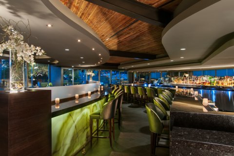 Jade bar with jade onyx drink rail and floral decor.