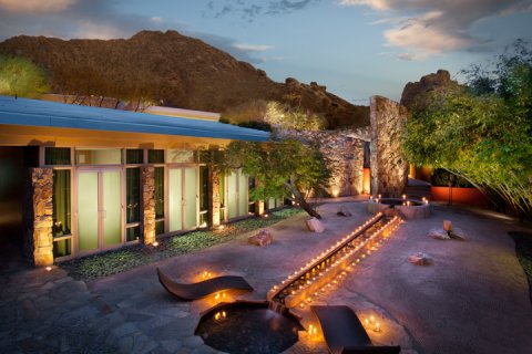 Overhead view of Sanctuary Spa's Zen Garden lit with candles at dusk.