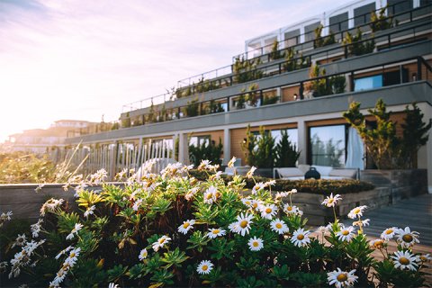 Spring flowers in front of the exterior of Gurney's Montauk Resort