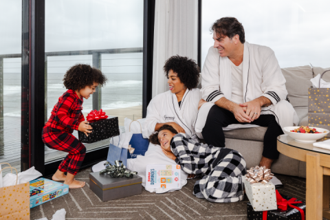 A family in pajamas opens presents at Gurney's Montauk Resort