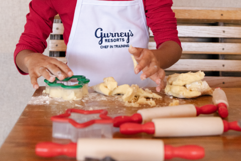 A closeup of a child playing with cookie dough
