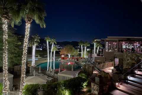 View of holiday lights decor at elements and Sanctuary's Infinity Pool at night.