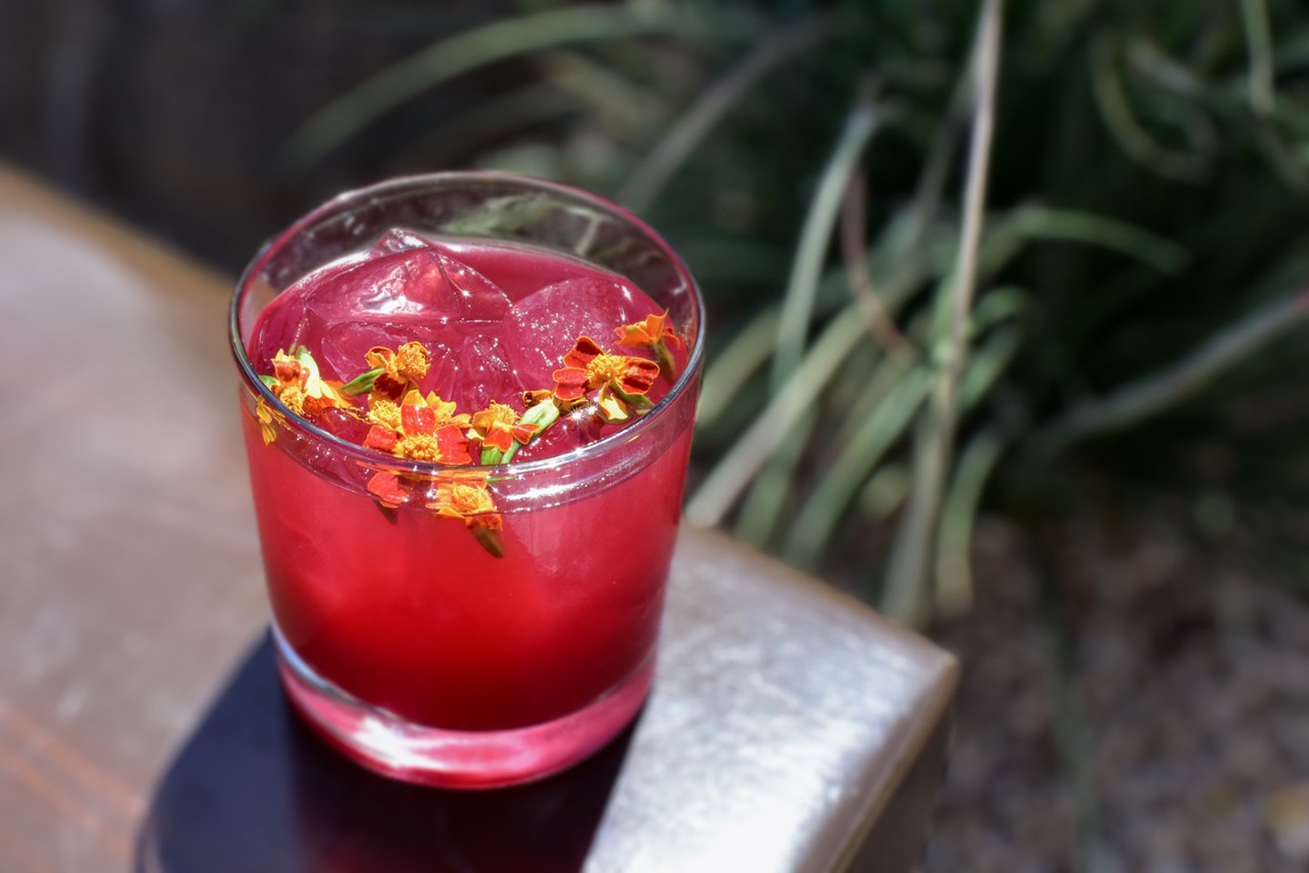 Nacho Libre cocktail with floral garnish.
