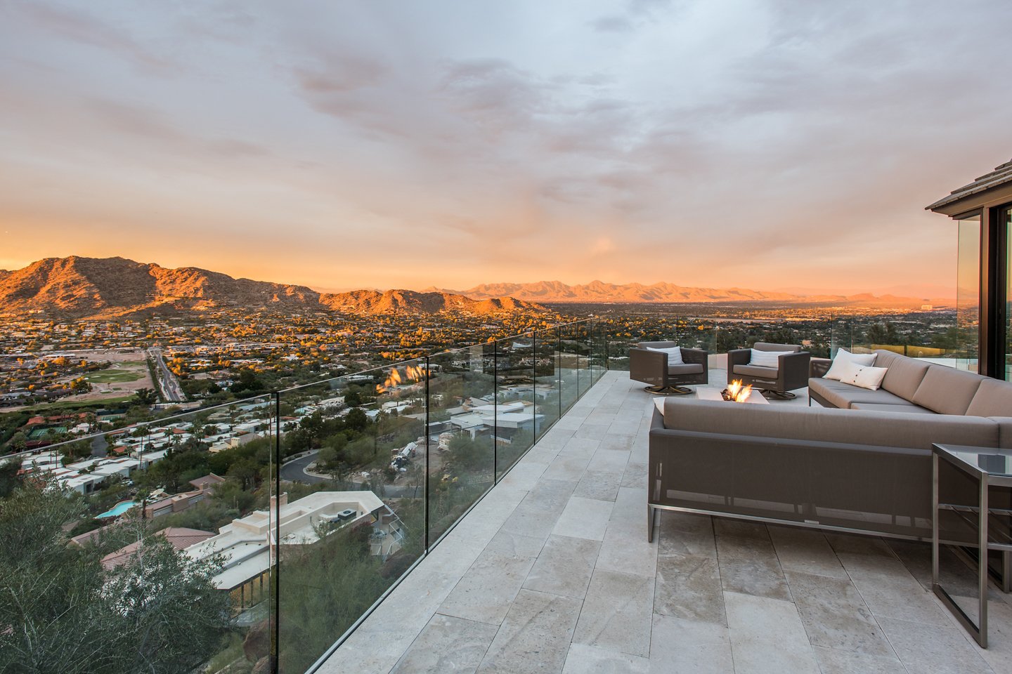 View from Villa Ventana patio at sunset with couch and fire pit.