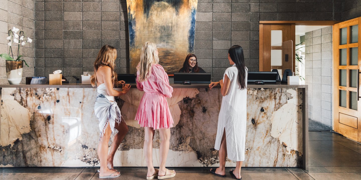 Three girlfriends checking in at Sanctuary Spa's front desk.