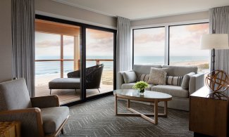 cottage living room with balcony overlooking the ocean 