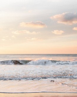 Sunset with waves crashing on the beach