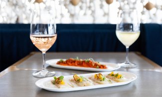 a glass of rose and glass of white wine with appetizers at Scarpetta