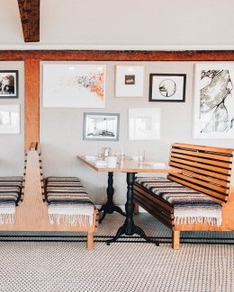 wooden slat booths with hung artwork at Tillie's