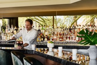 Bartender pouring a cocktail at jade bar.